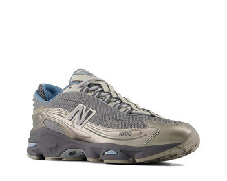 New Balance 1000D Arid Stone vista lateral — parte superior malla gris pizarra natural